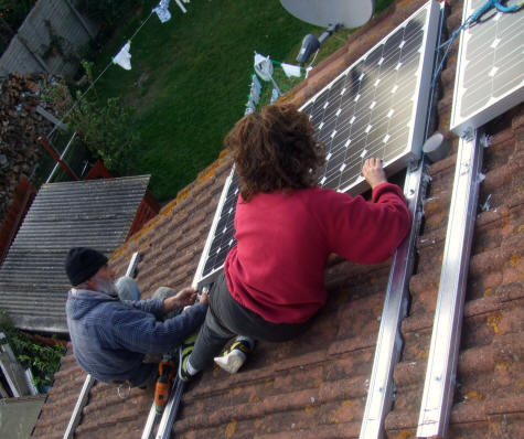 Rosie and Chris fitting the solar PV panels